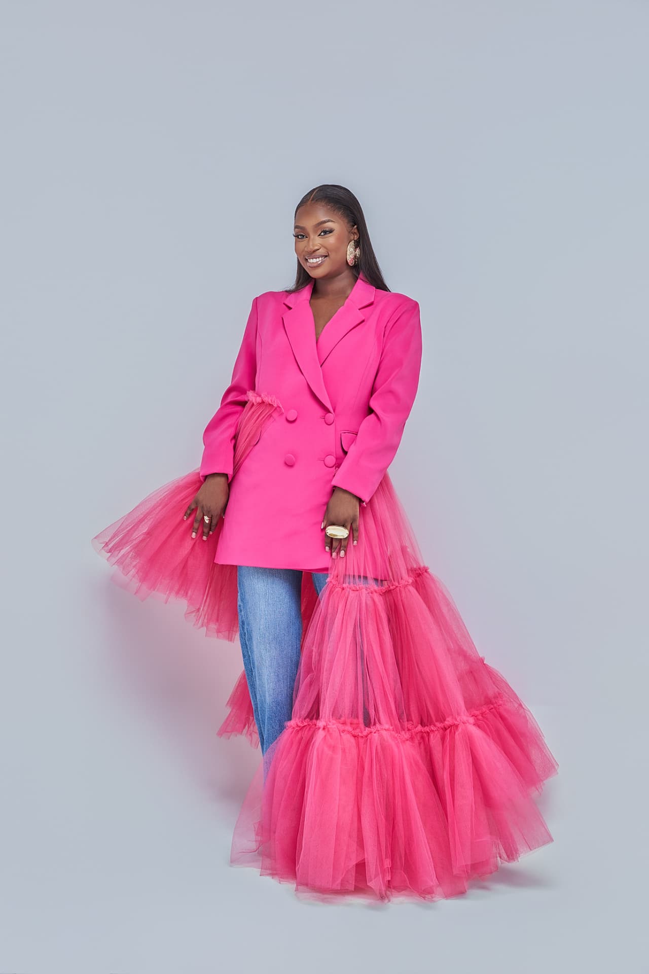 Musa Yende in a hot pink blazer with tulle skirt