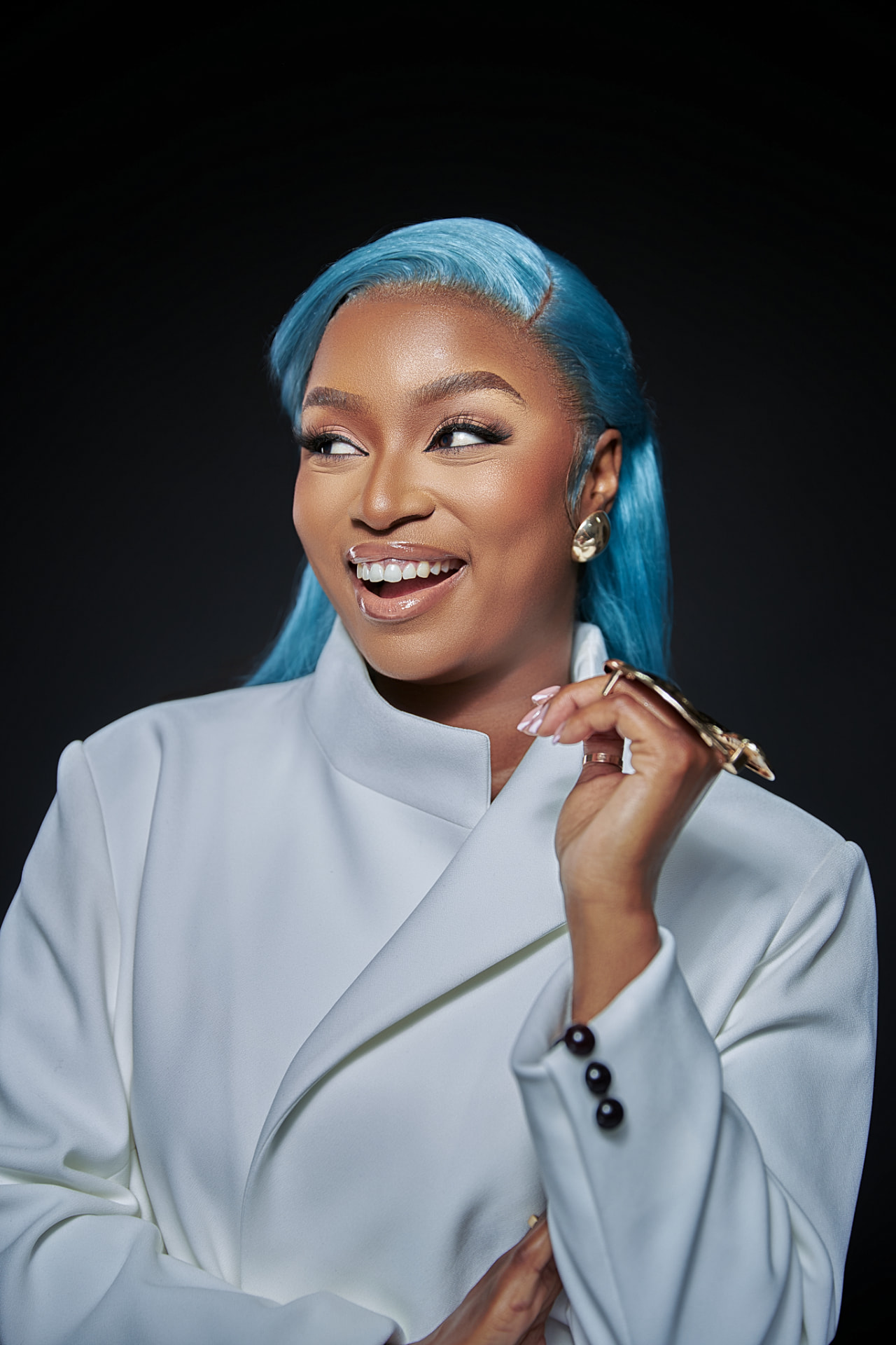 Musa Yende in a white blazer against a black backdrop